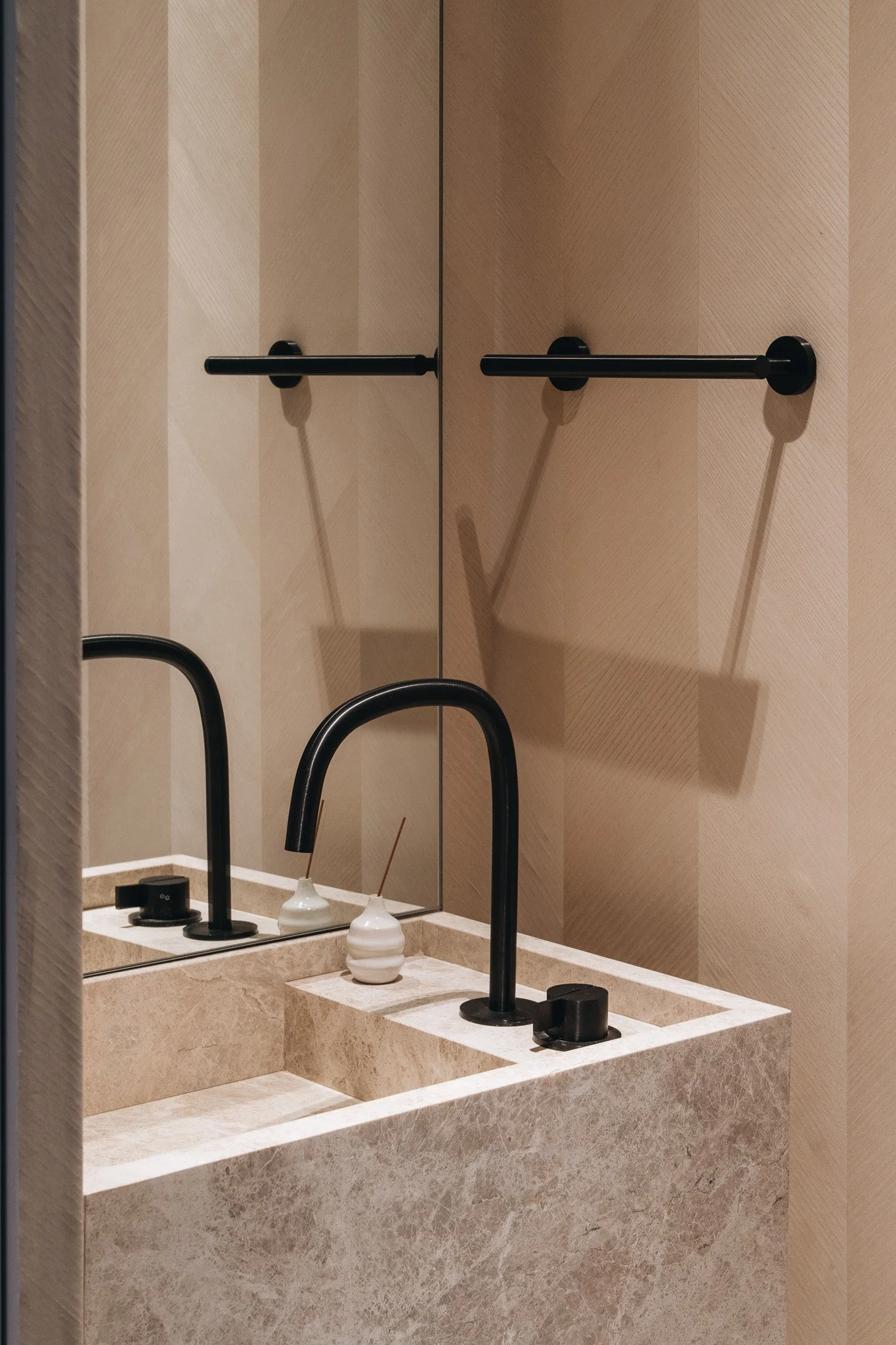 Powder Room showcasing a wall hung marble vanity with black plumbing fixtures.