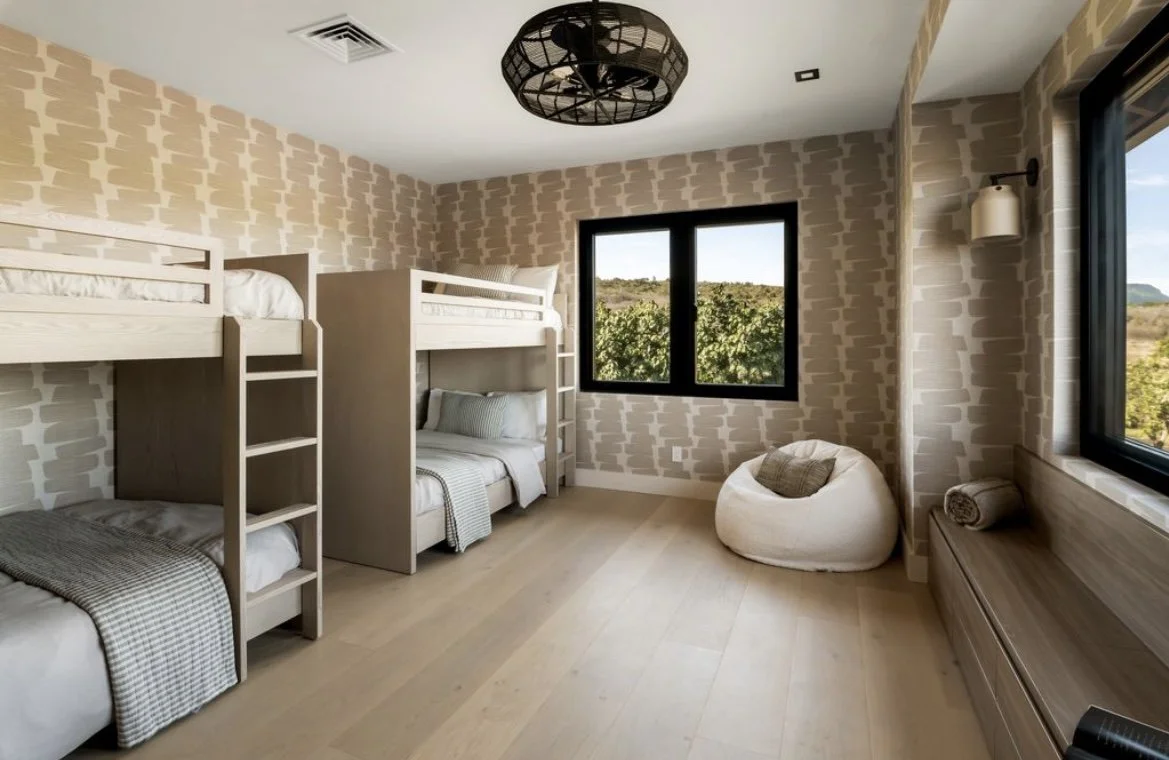 This bunk room features a playful vinyl wallpaper that mimics rock formations found on Kauai. Two queen size bunk beds make this space perfect for kids or adults alike.