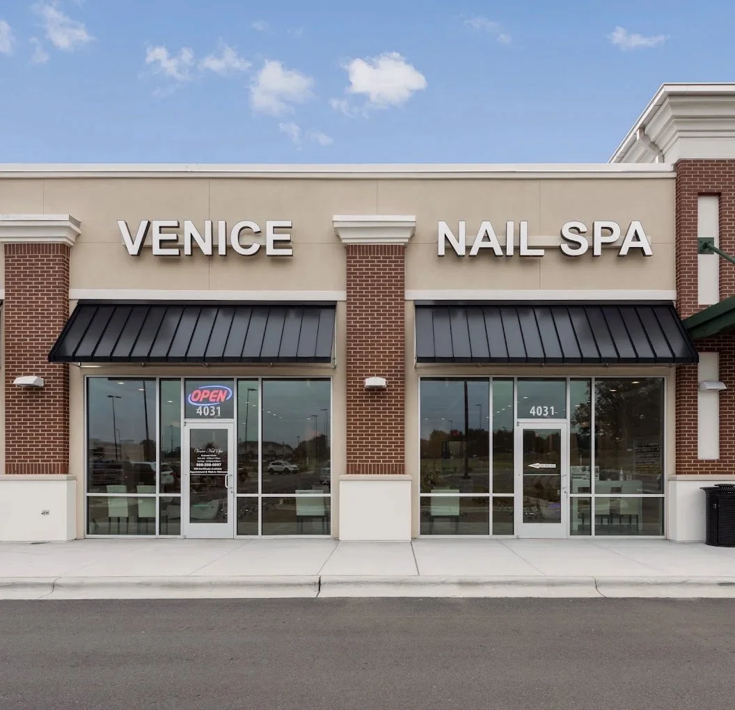 Facade of a nail spa named 'Venice Nail Spa' with glass entrance doors, black awnings, and a sign indicating it is open, located at 4031.