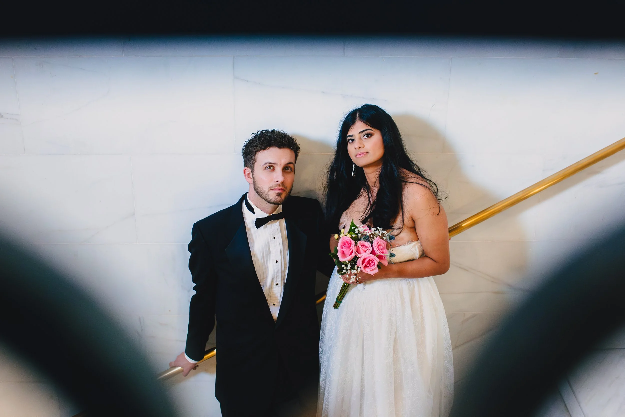 Newlyweds on the stairs in San Francisco City Hall