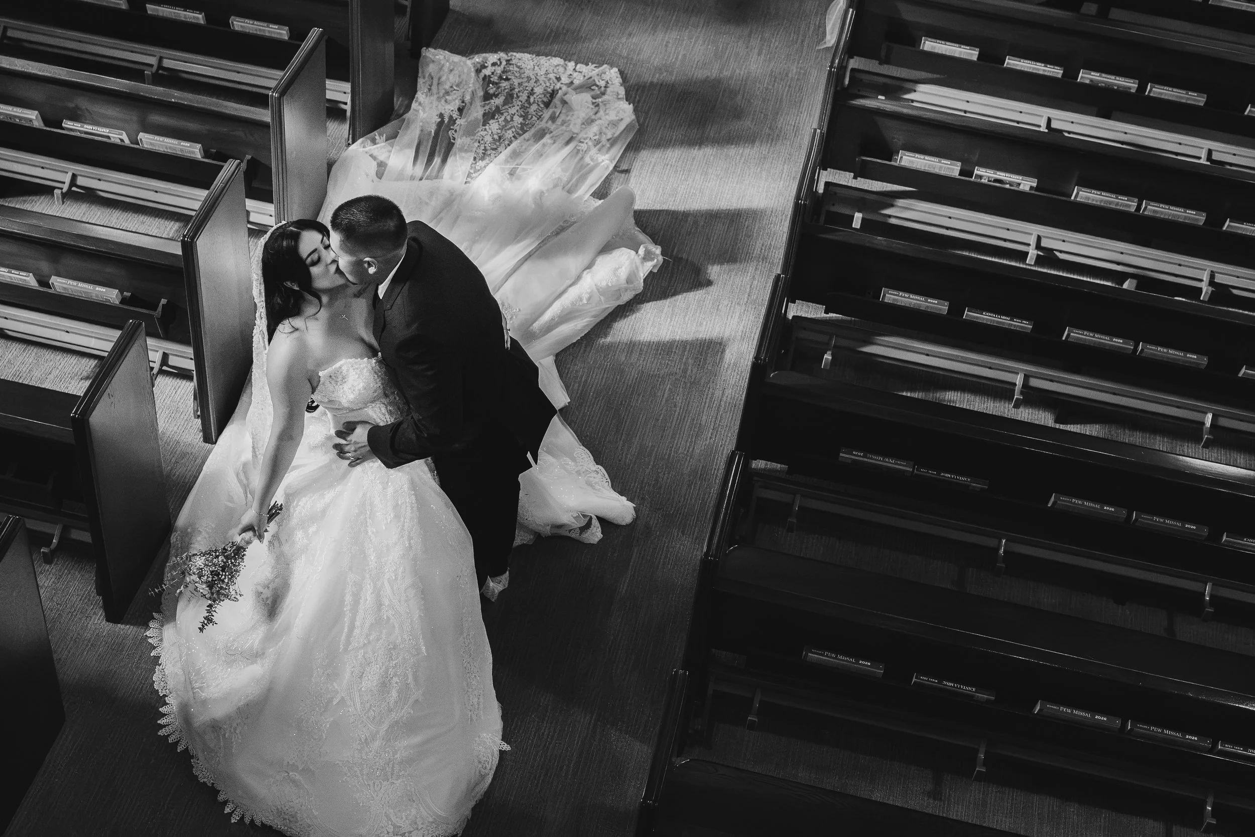 couple kissing at a church wedding