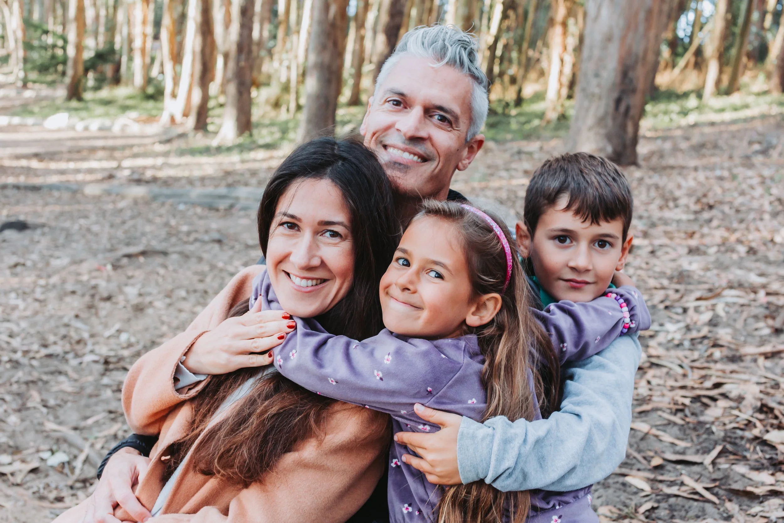 Hugging family with two kids at Andy Goldsworthy's Wood Line