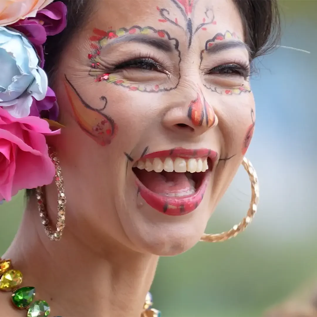 Image shows a close up of a lady's smiling face.