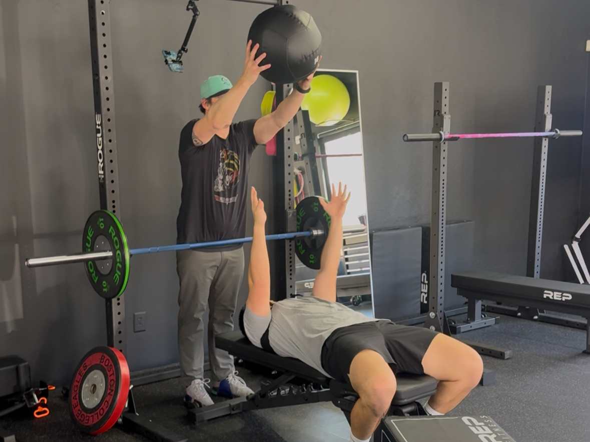Training upper body plyometric and ballistic movement with a supine medicine ball chest pass.