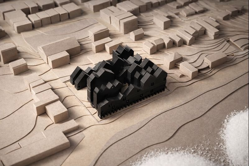 The design uses a mix of low-rise and high-rise shapes to respond to the massive salt storage facility across the street