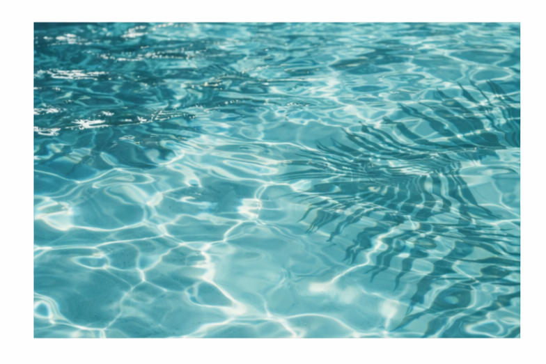 Close-up of clear blue water with ripples and reflections.