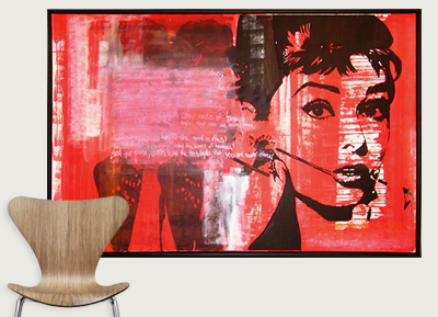 A large pop art-style painting of a woman with short hair and a headset, set against a red background, hangs on a white gallery wall.