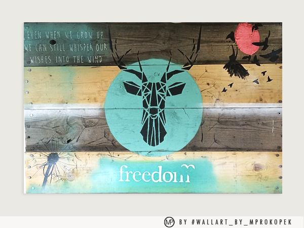 Wooden wall art featuring a black geometric deer head inside a teal circle. Above it, there's a quote: "Even when we grow up we can still whisper our wishes into the wind." To the right, a pink moon with a black bat and flying birds. Below, the word 