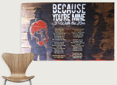 Wall art with a red heart and white text that reads 'Because you're mine I walk the line'.