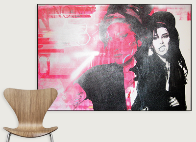A colorful artwork of a man and woman, with a pink and black abstract background, displayed on a wall in a room.