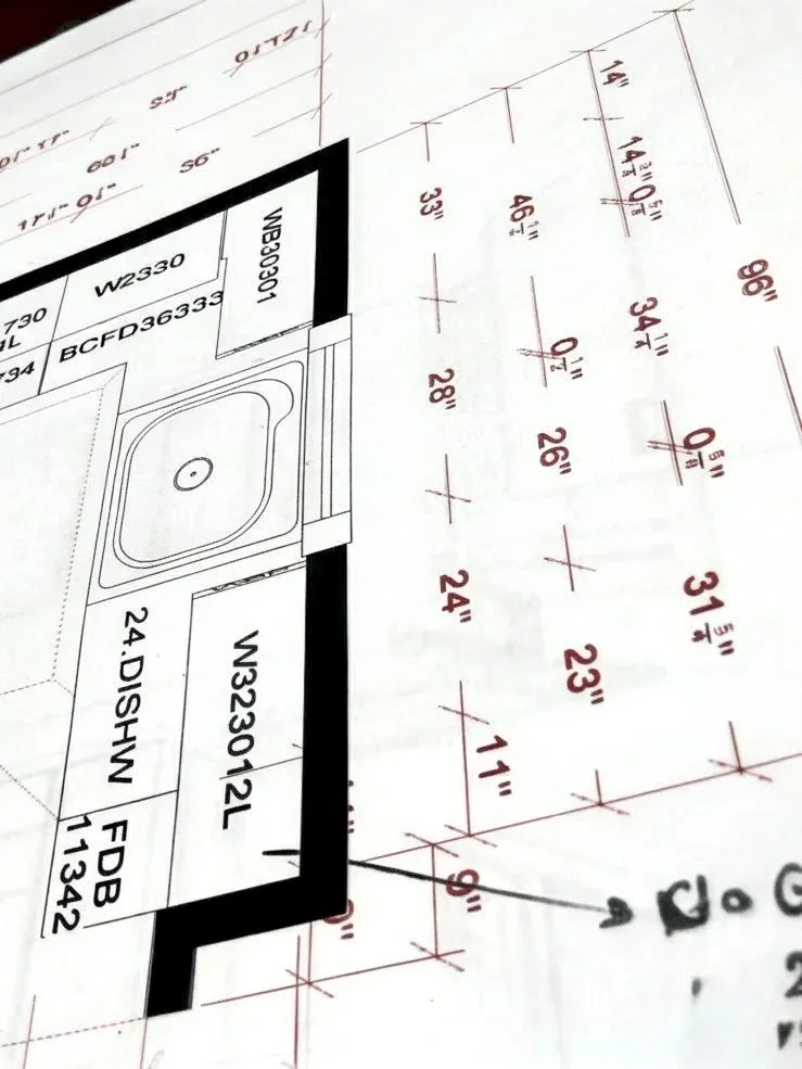 Architectural blueprint showing detailed measurements and layout for a section of a building including a sink and a dishwasher.