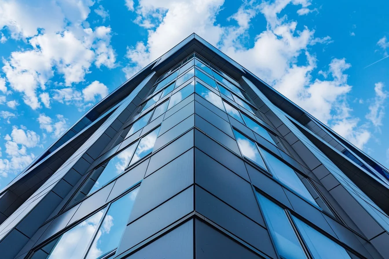 Specialist render spraying being applied to commercial property exterior using professional spray technology.