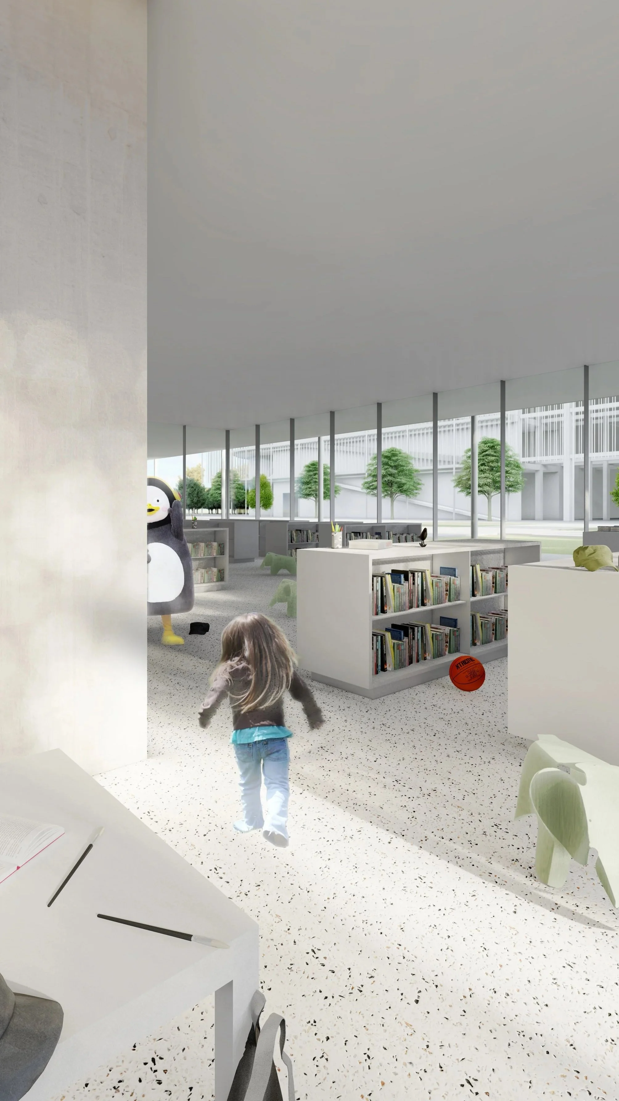 Interior of a modern library with a child walking and a person dressed in a penguin costume in the background, along with shelves of books and decorative elements like an elephant sculpture