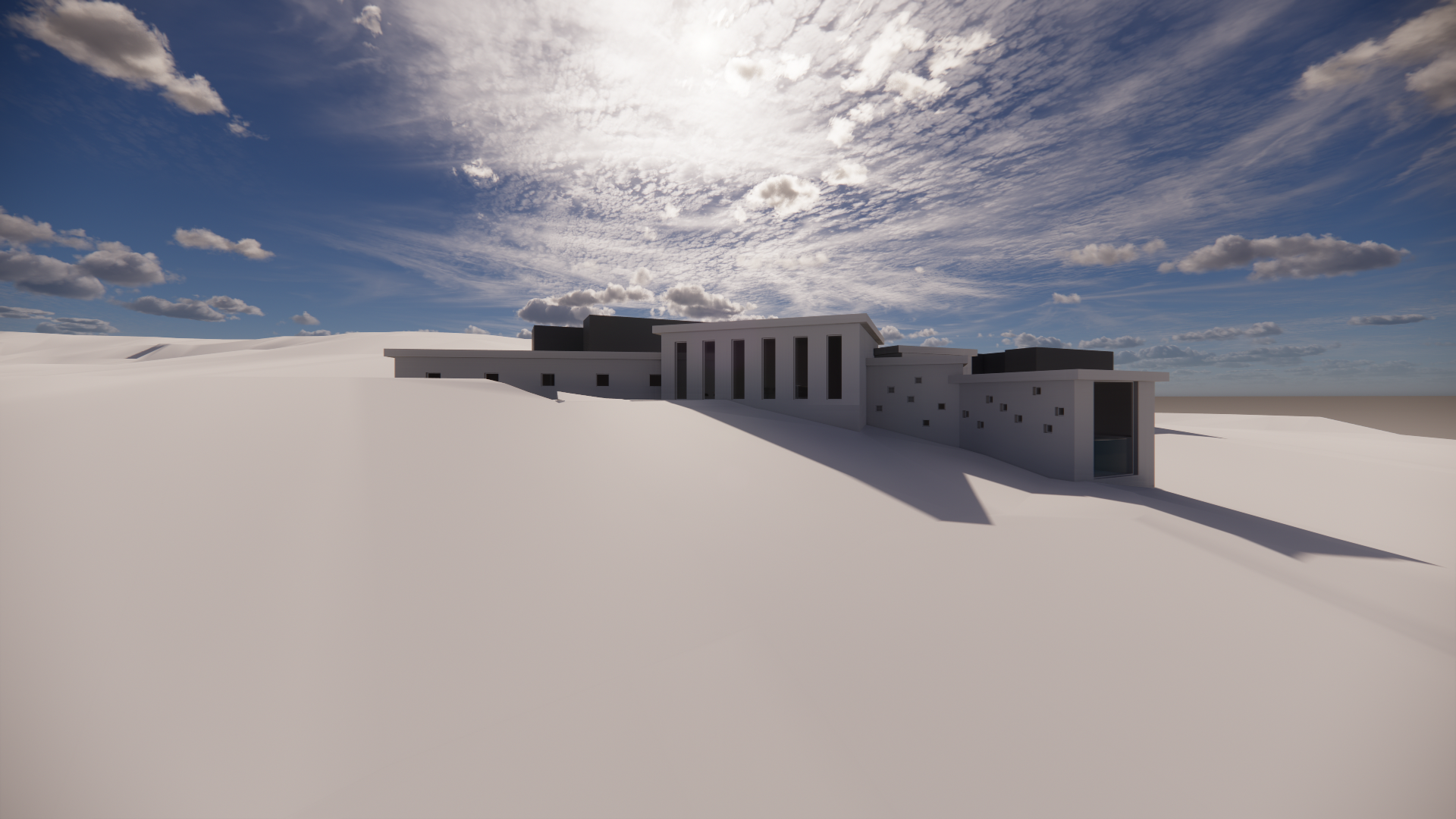 Modern white building with multiple levels and large windows, situated on a snowy landscape under a partly cloudy sky with the sun shining.