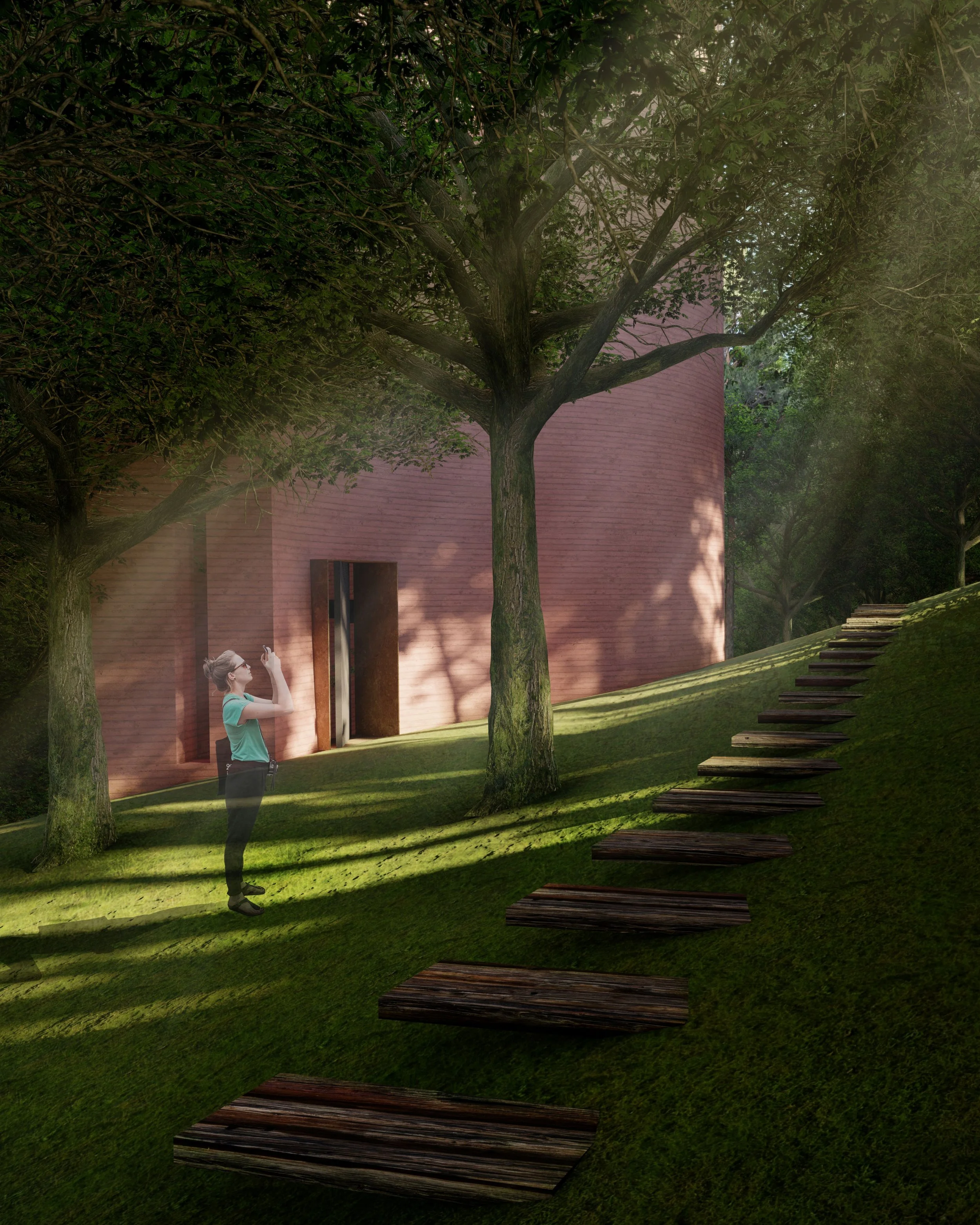 A woman standing on a grassy hill, taking a photo of a modern building with a brick facade, surrounded by tall trees and a wooden pathway leading uphill.