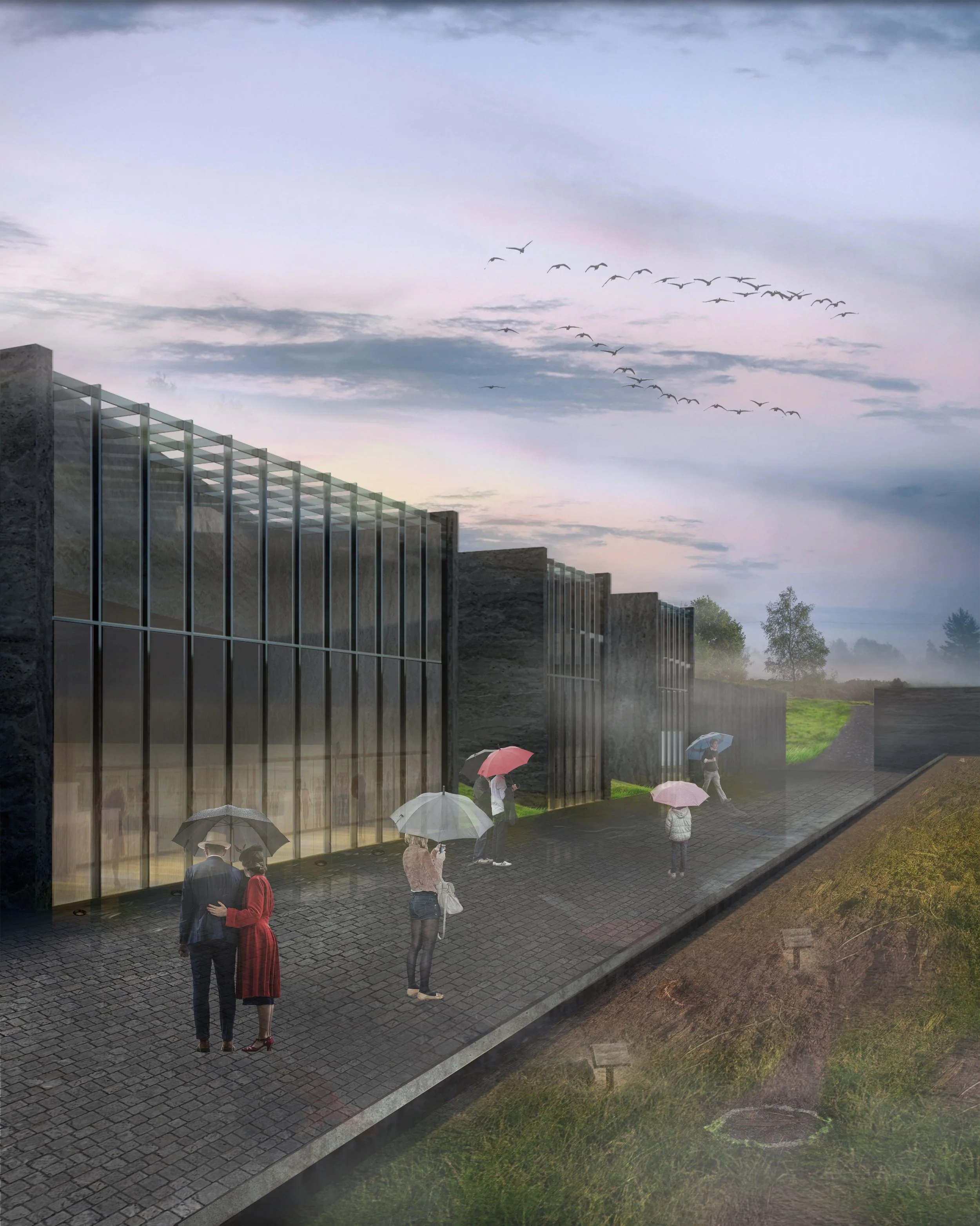 People with umbrellas standing on a paved walkway outside a modern building on a misty, overcast day with birds flying in the sky and trees in the background.