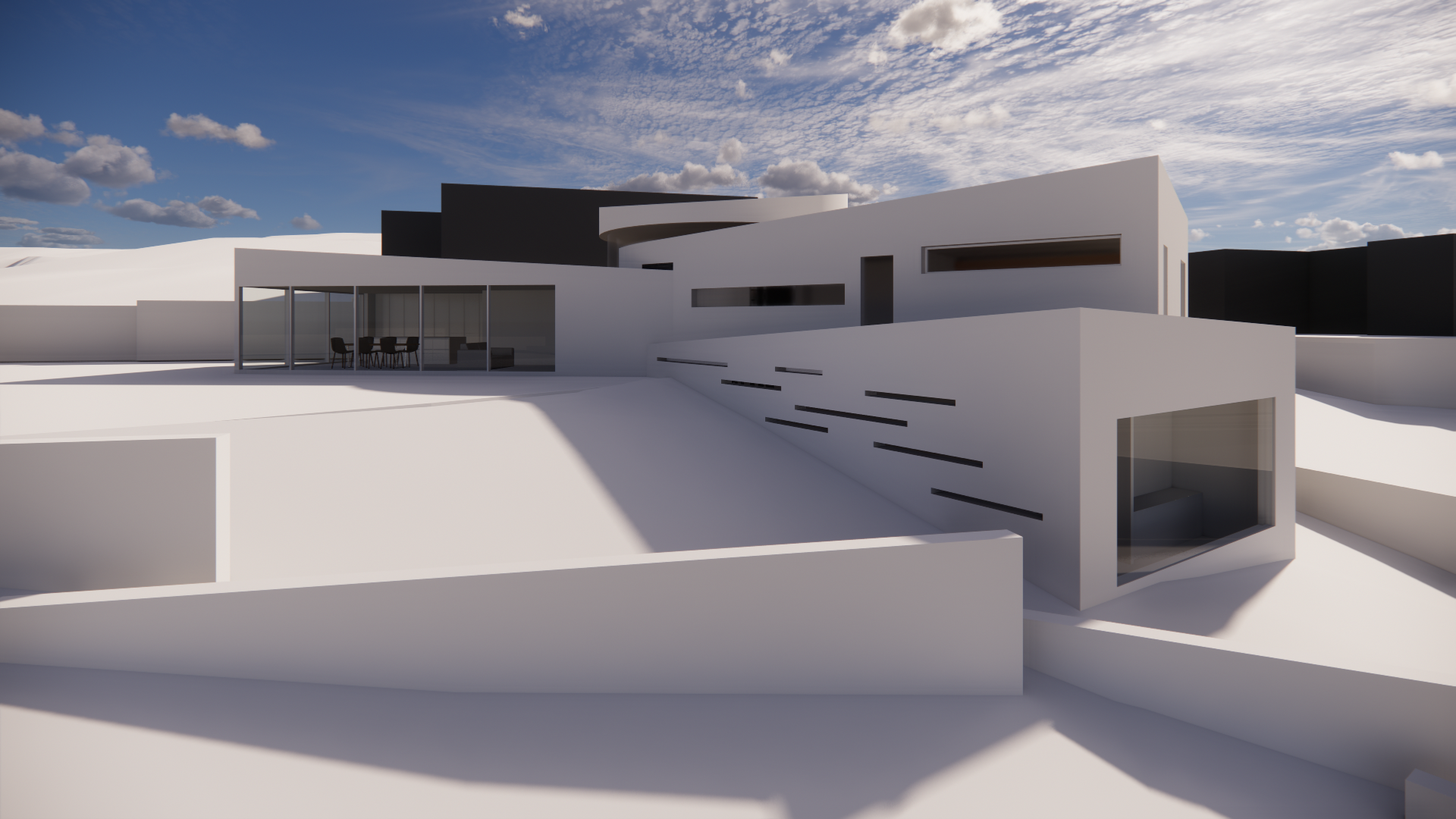 Modern white and black architectural house with large glass windows and outdoor seating area, under a partly cloudy sky.