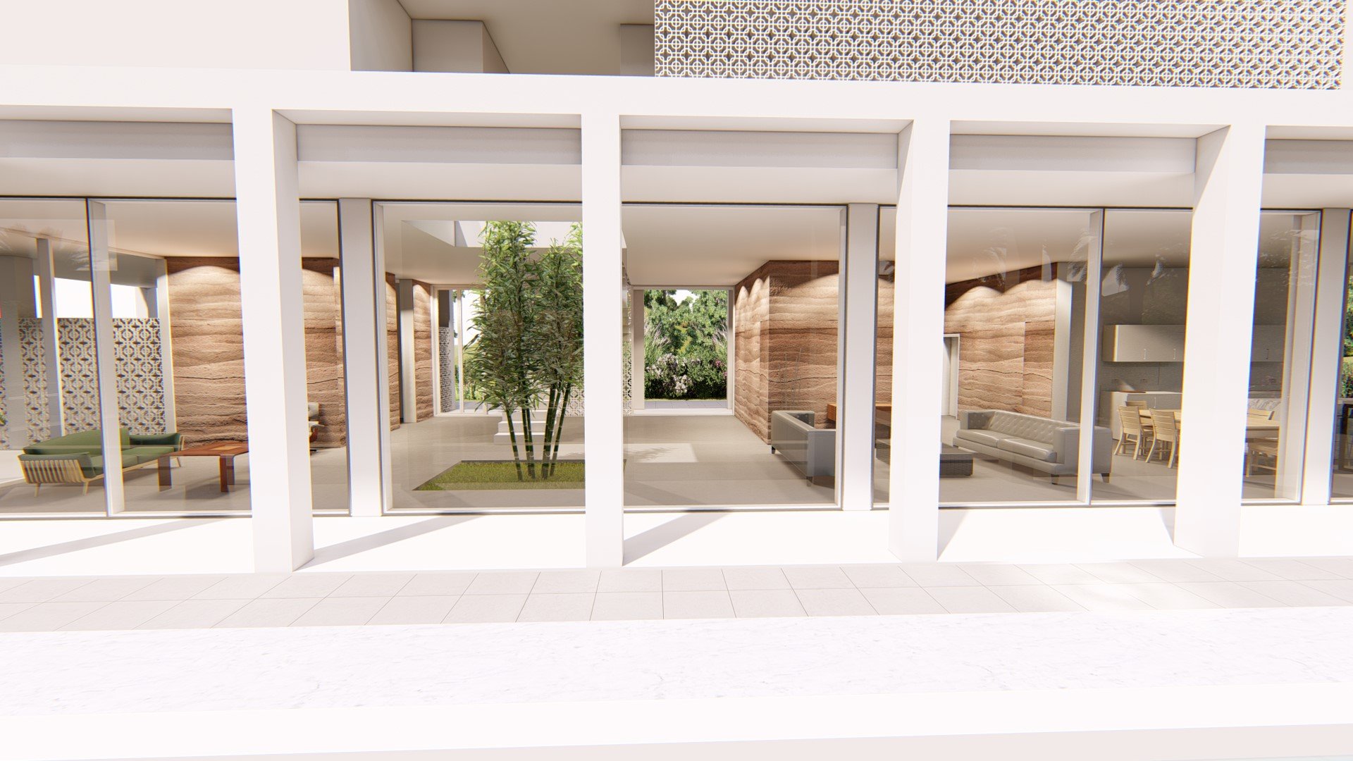 Interior view of a modern building lobby or common area with large glass windows, seating areas with sofas and chairs, and a central indoor garden with a small tree