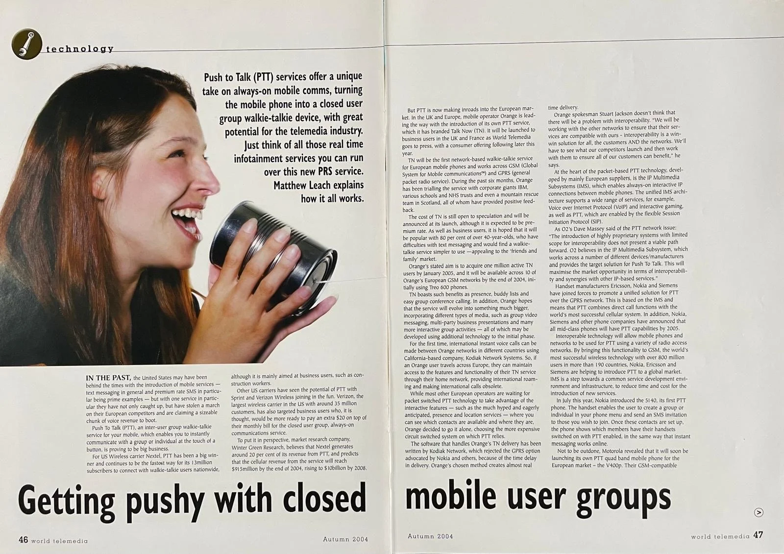 A smiling young woman speaking into a black walkie-talkie.