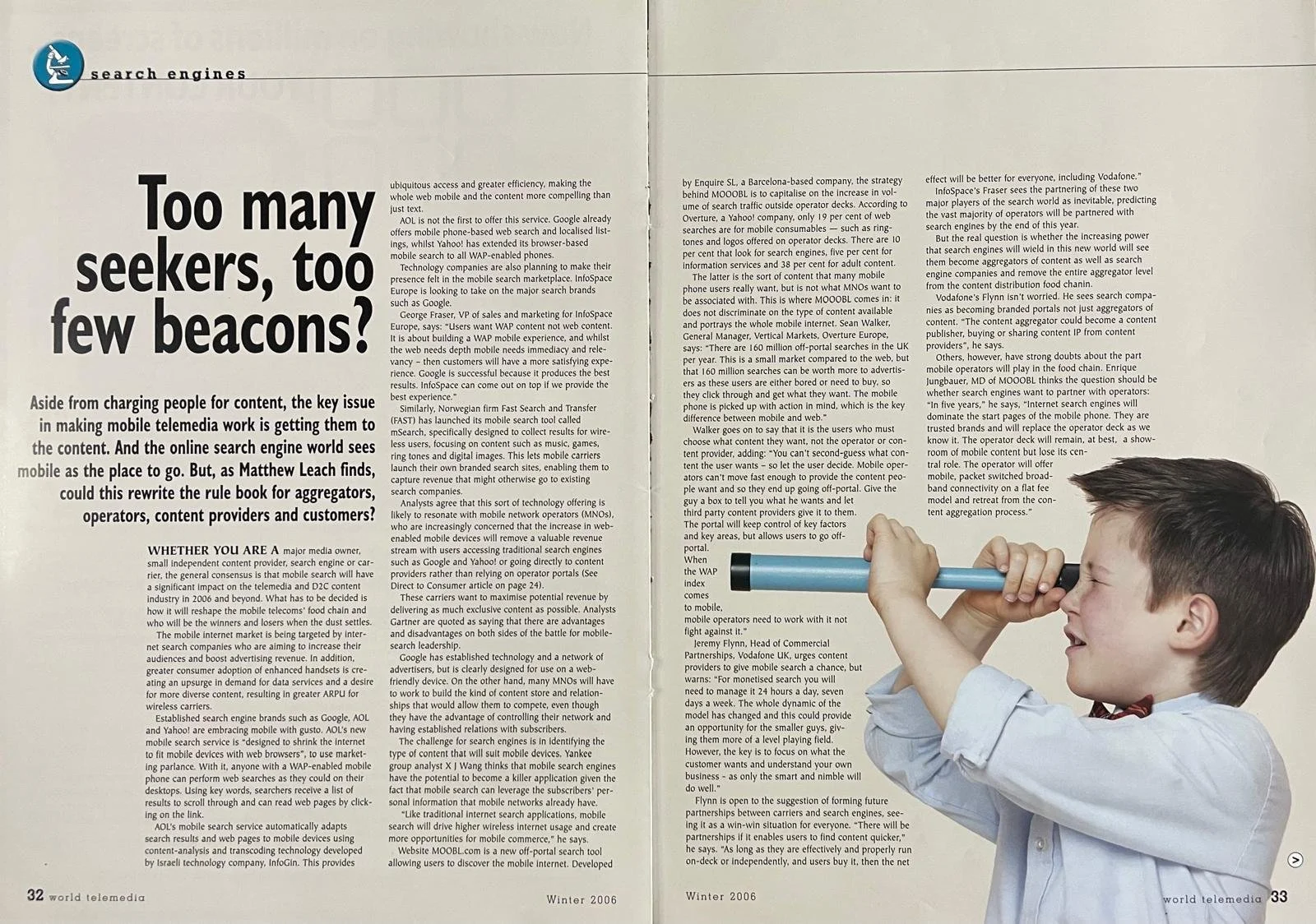 A young boy with brown hair and a white shirt holding a blue and black toy telescope to his eye, smiling while looking through it.