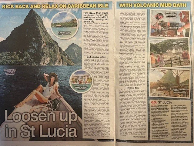 Travel magazine spread with images of Caribbean island scenery, a woman relaxing on a boat, and various activities like mud baths, tropical food, and a chocolate box. Headline reads 'Loosen up in St Lucia'.