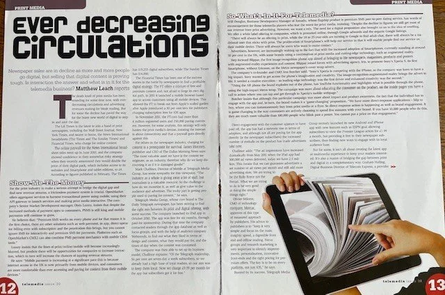 Open magazine with a hand pointing at a spinning, colorful page