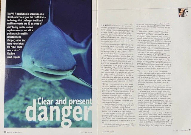 A magazine spread with a large image of a shark on the left page and text on the right page, discussing Wi-Fi technology and potential dangers.