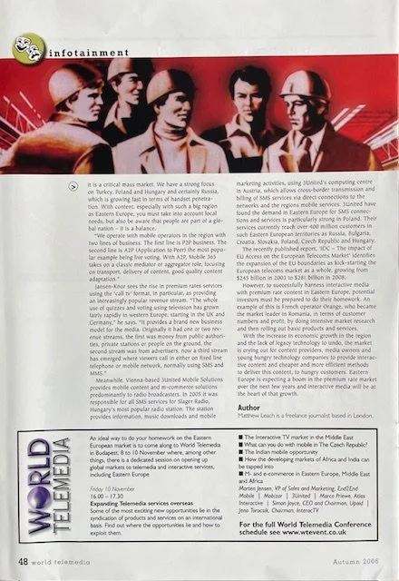 Group photo of individuals in safety helmets and business attire, with a red background and the World Telemedia logo.