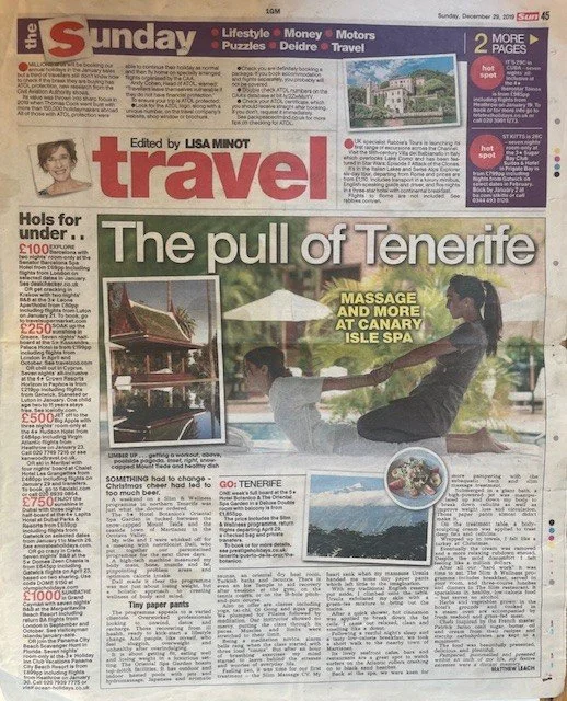 The front page of a Sunday newspaper focusing on travel in Tenerife, featuring a large image of two people practicing yoga outdoors at Canary Isle Spa, with an inset photo of a spa pool and another smaller image of a scenic coastline.