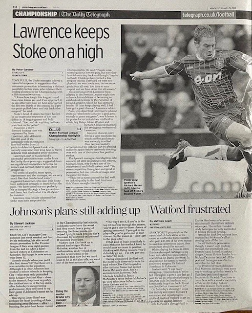 Photograph of a football player in action, kicking a ball during a game, with a goalkeeper about to block the shot.