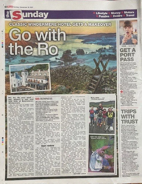 A newspaper page with the headline 'Go with the Ro,' featuring a large landscape photo of a river and coastline, inset photo of a hotel building, and smaller images including children in life jackets, a person in a pink rabbit costume, and a woman.