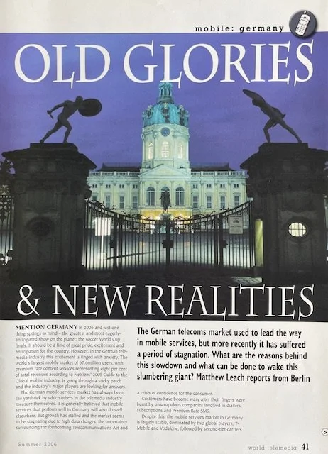 Magazine cover titled 'Old Glories & New Realities' with a German government building in the background and two statues on either side.