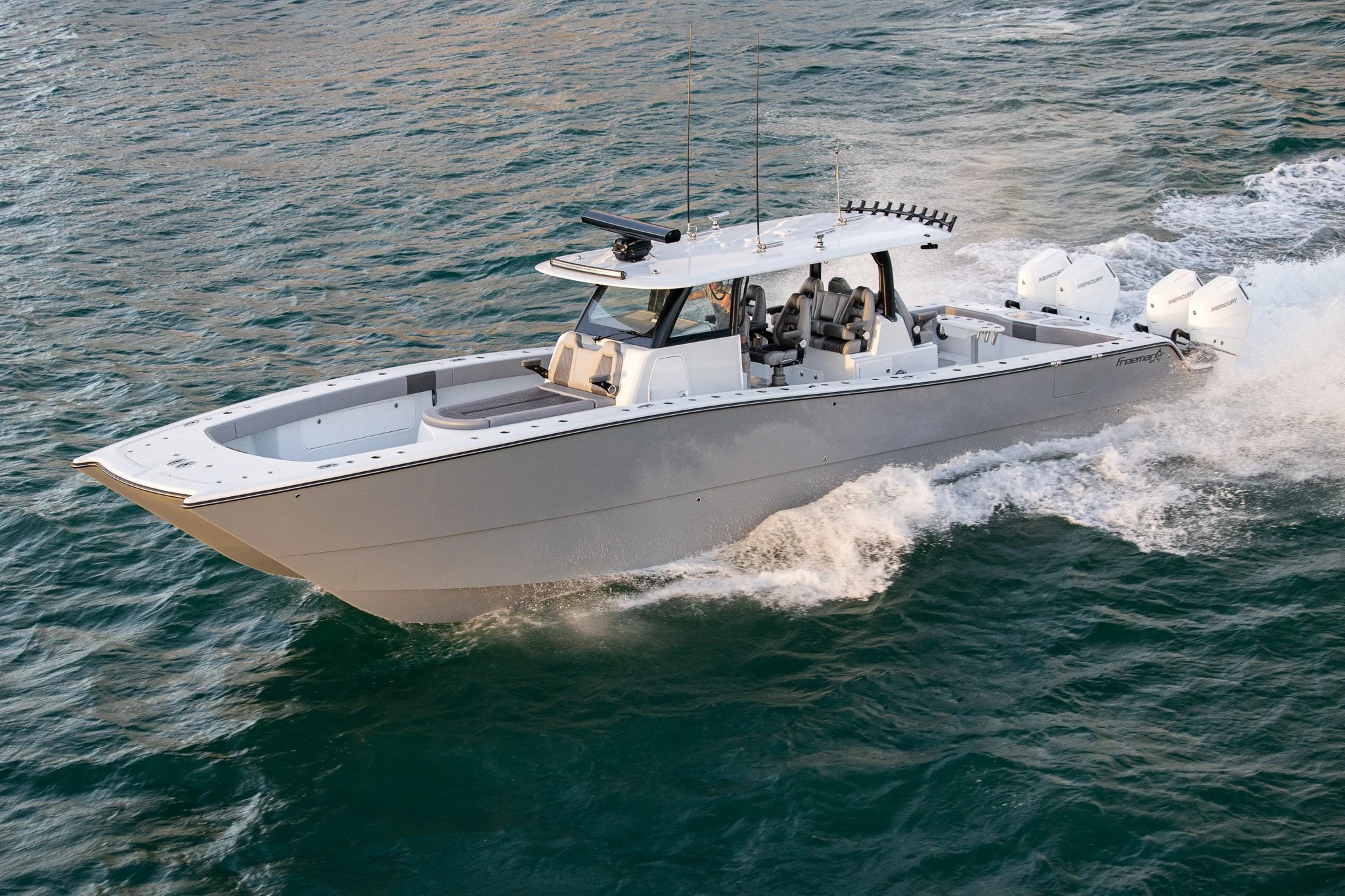 A new Freeman boat creating a wake in the water.