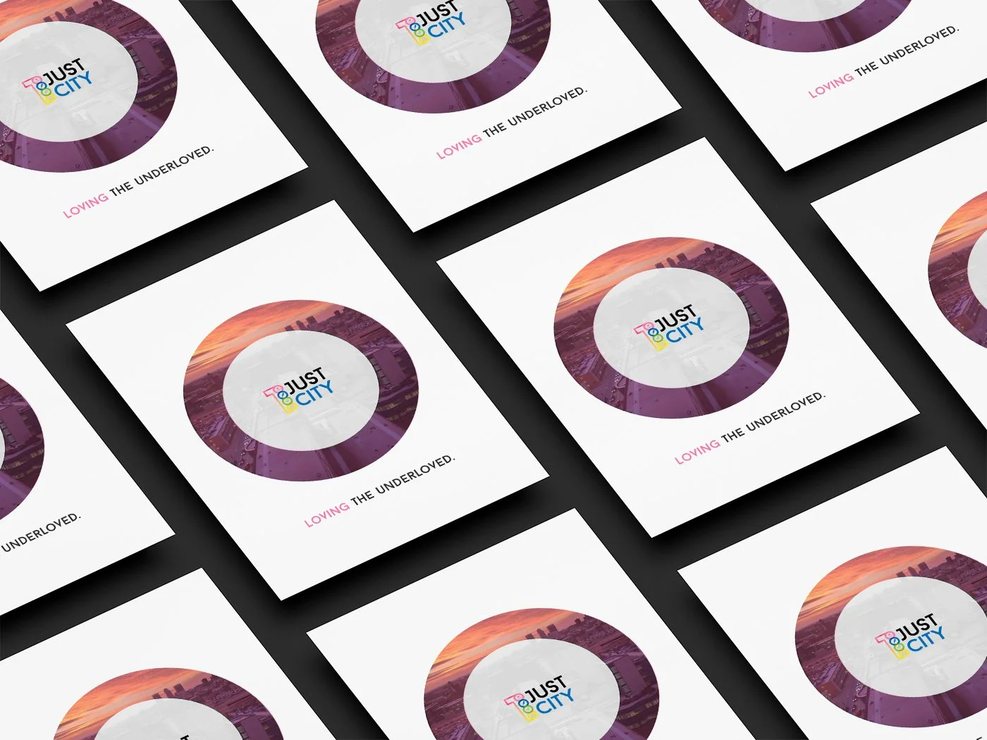 Multiple flyers for Just City with a circular logo and a cityscape background, featuring the slogan "Loving the Underloved".