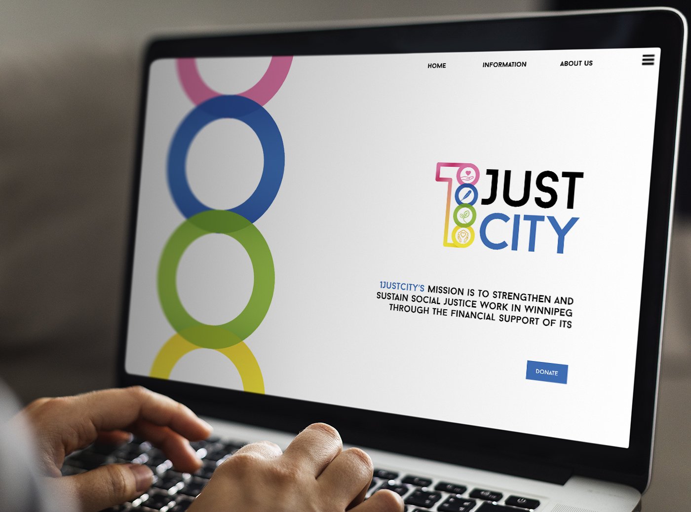Computer screen displaying the website of 1JUSTCITY, which has a colorful logo with the words '1JUST CITY' and a mission statement about strengthening social justice work in Winnipeg.