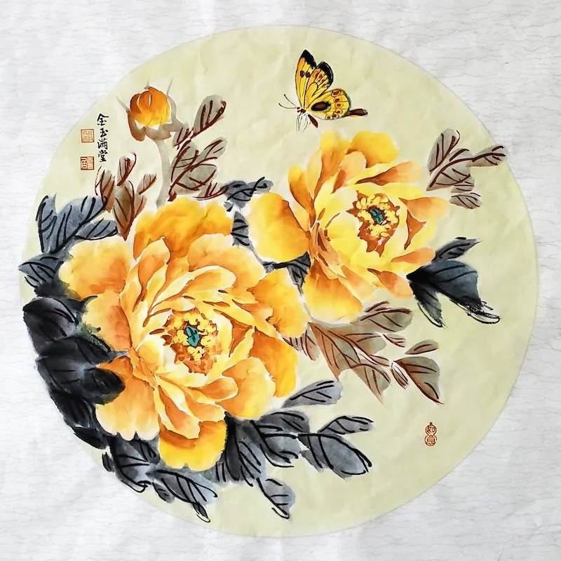 Traditional Asian painting of yellow peonies with dark leaves and two butterflies on a light background.