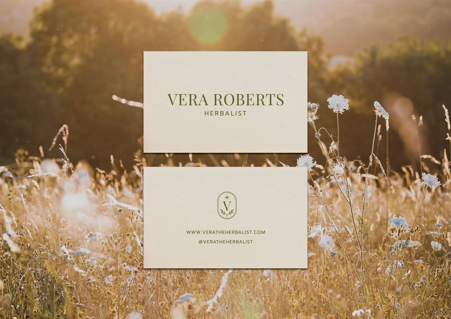 Business card design for a herbalist, overlaying a field of wildflowers at sunset with trees in the background.