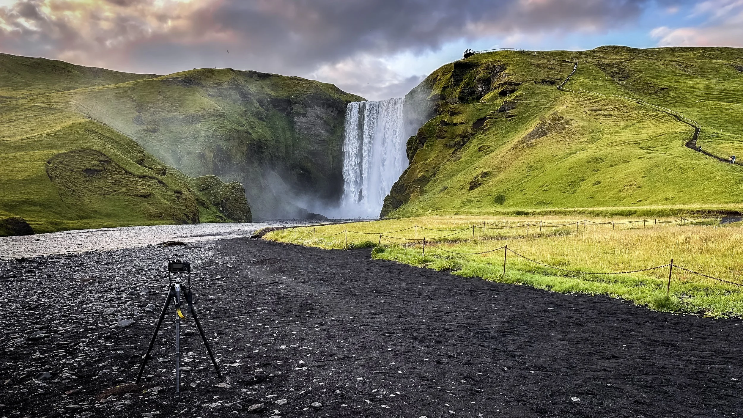 The powerful Skógafoss waterfall in South Iceland, a wide curtain of water dropping 60 meters over a green cliff