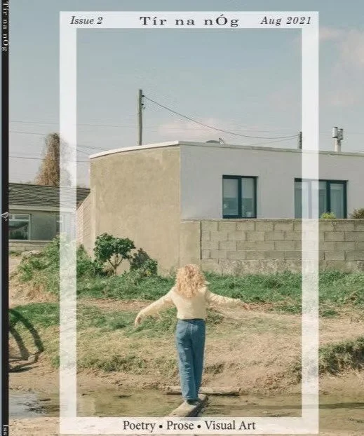 Magazine cover for "Tír na nÓg," Issue 2, August 2021. Features a person with curly hair standing outdoors, facing away, arms outstretched, with a modern house and blue sky in the background. Text includes "Poetry • Prose • Visual Art."