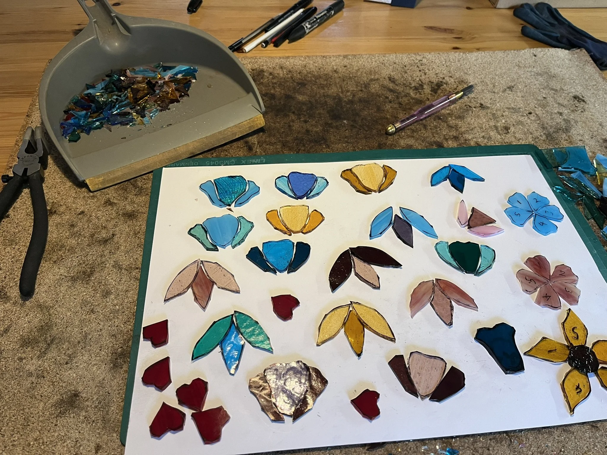 Stained glass flowers cut and ready for foiling.