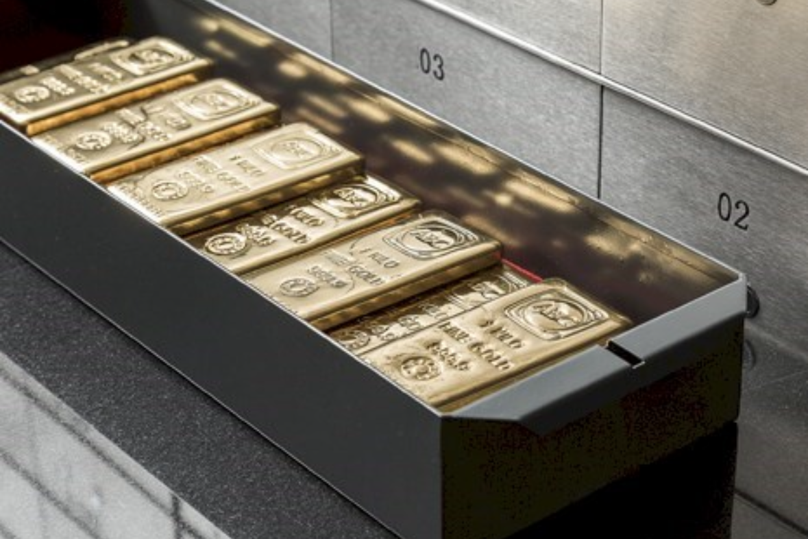 A secure cash drawer containing stacks of gold bars with the branding 'Fort Knox' visible on them.