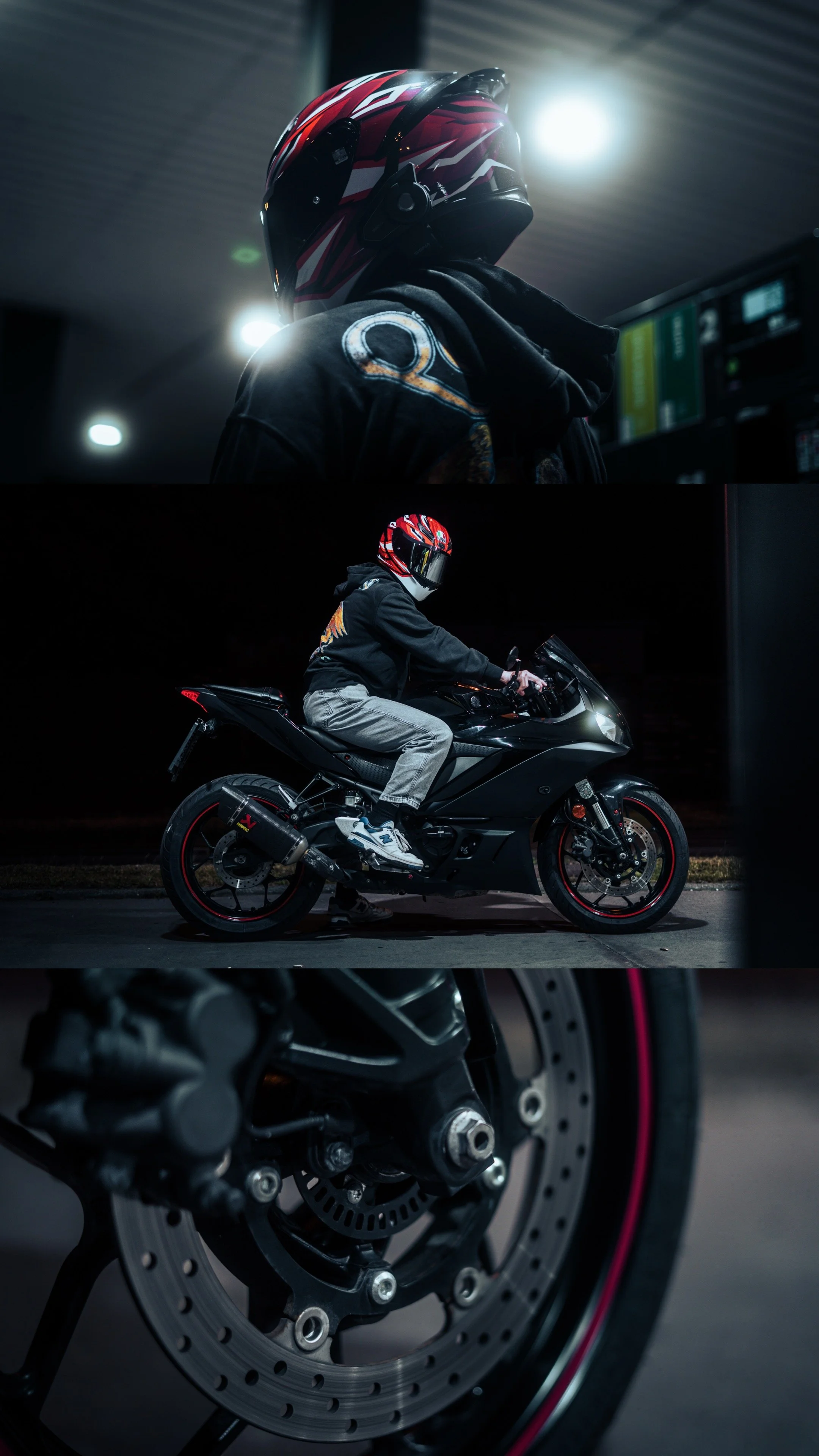 A person wearing a red and black motorcycle helmet, dark hoodie, and jeans, riding a black sport motorcycle at night. The background shows a dark outdoor setting with some light, and a close-up of the motorcycle's disc brake is also visible.