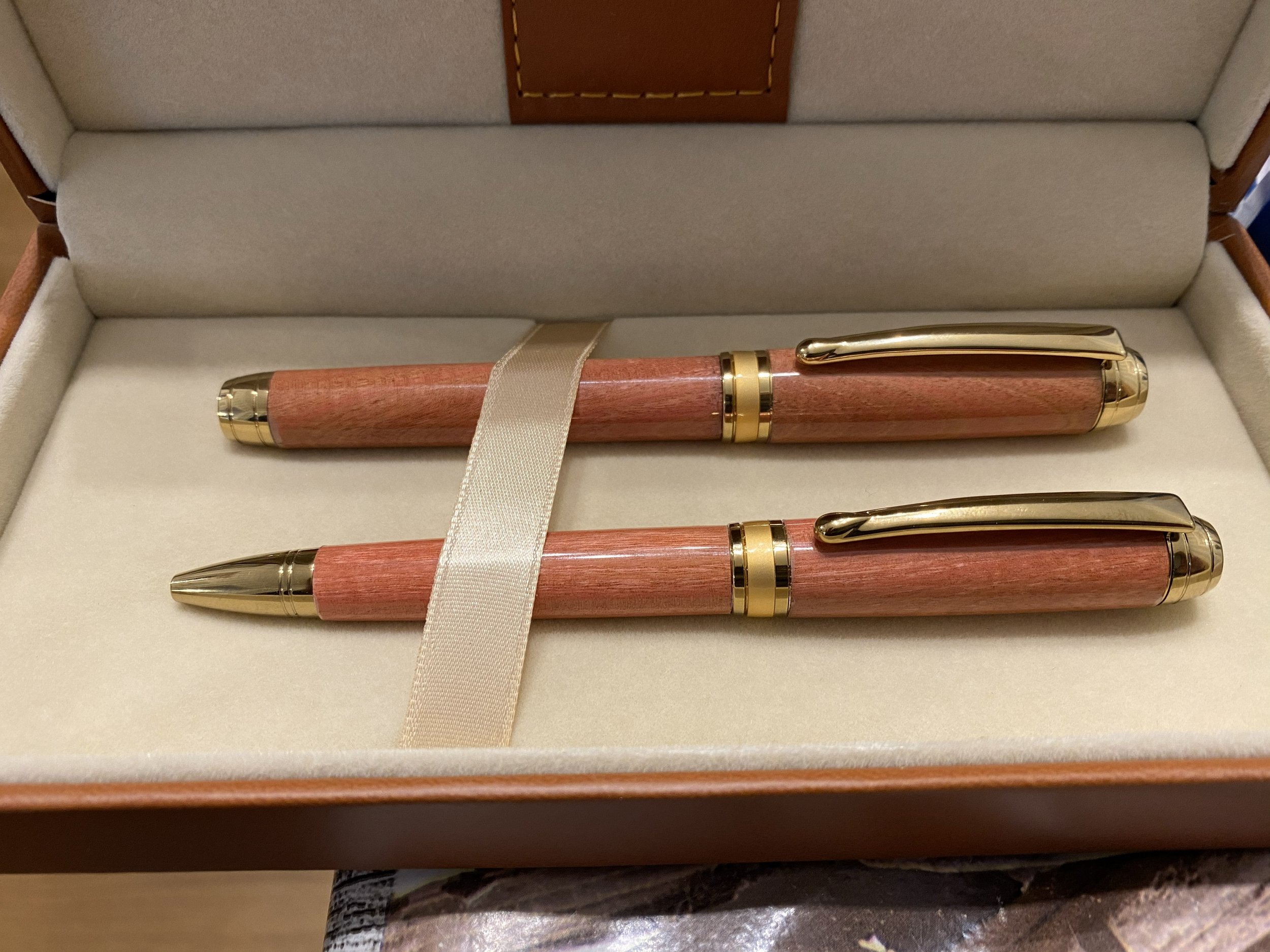 I specialise in making high-quality pens from the ultimate materials. These gold-plated pens are made from a rare wood called pink ivory and matched the colour scheme at the couple's wedding.