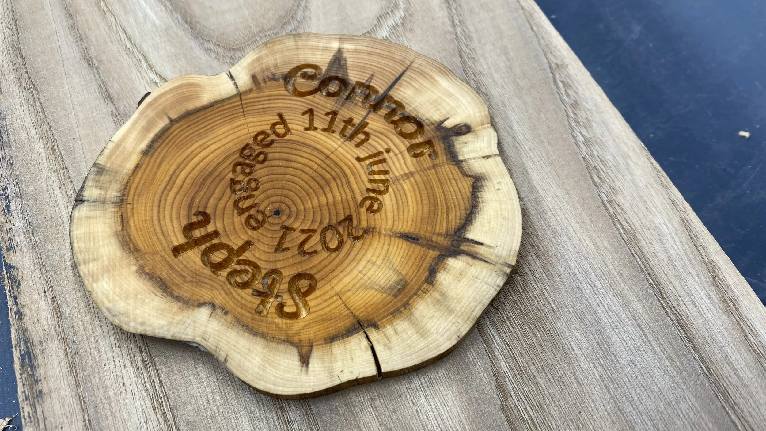 These coasters were cut from local Yew and were carved rather than engraved. They were used at the couple's engagement party.