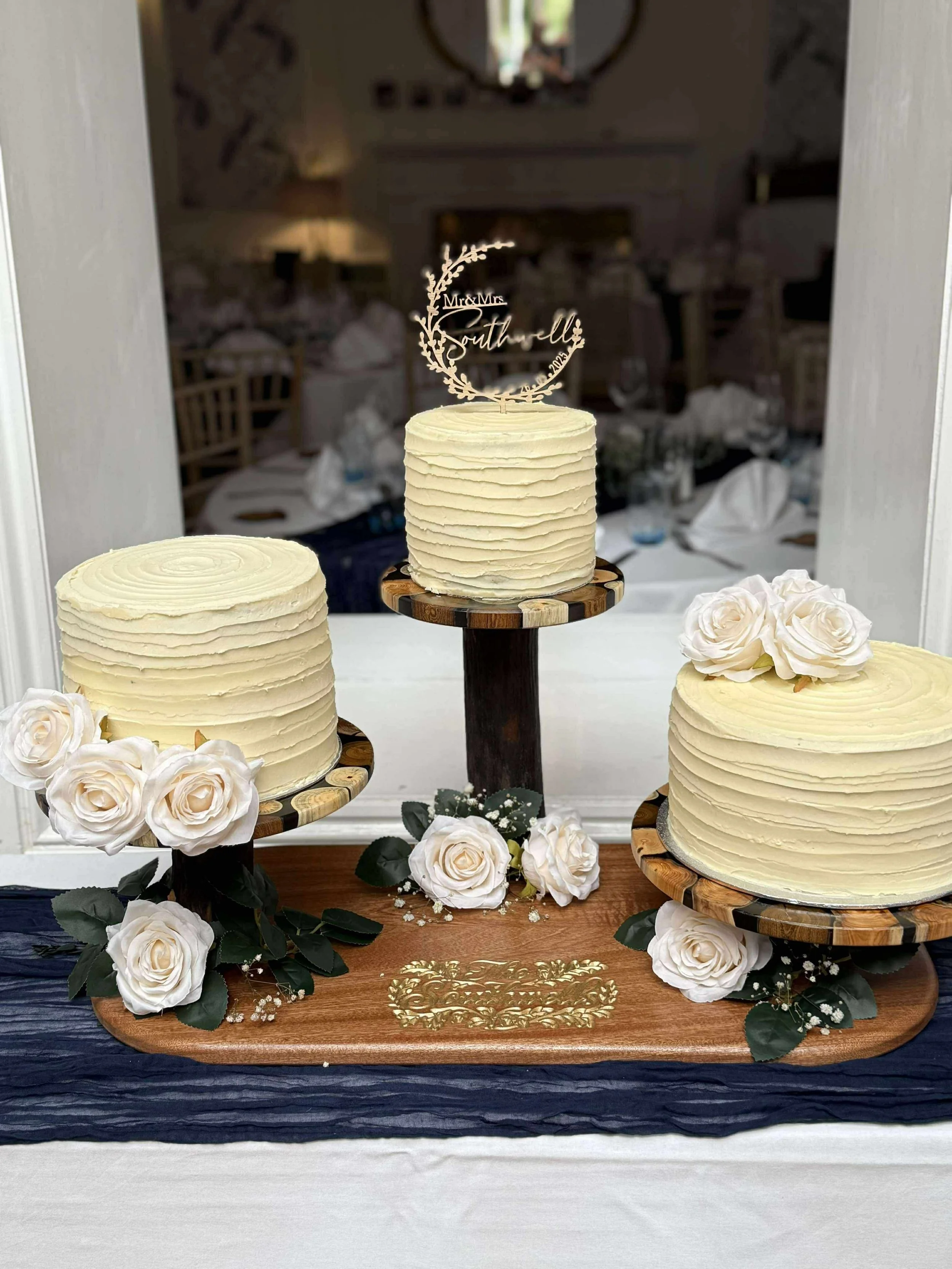 A custom carved cake stand with wood and resin platters for the cakes.