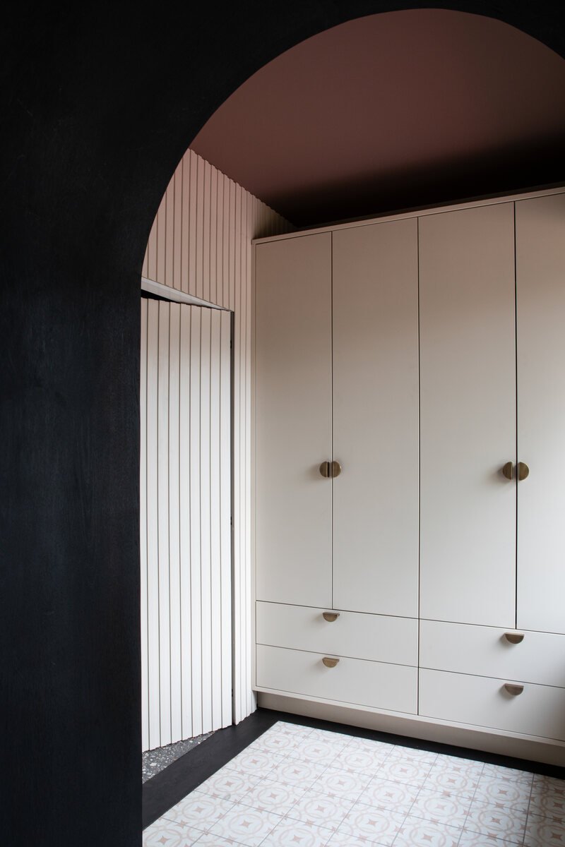 Painted fitted wardrobes with dark timber detailing by Royal & Co.