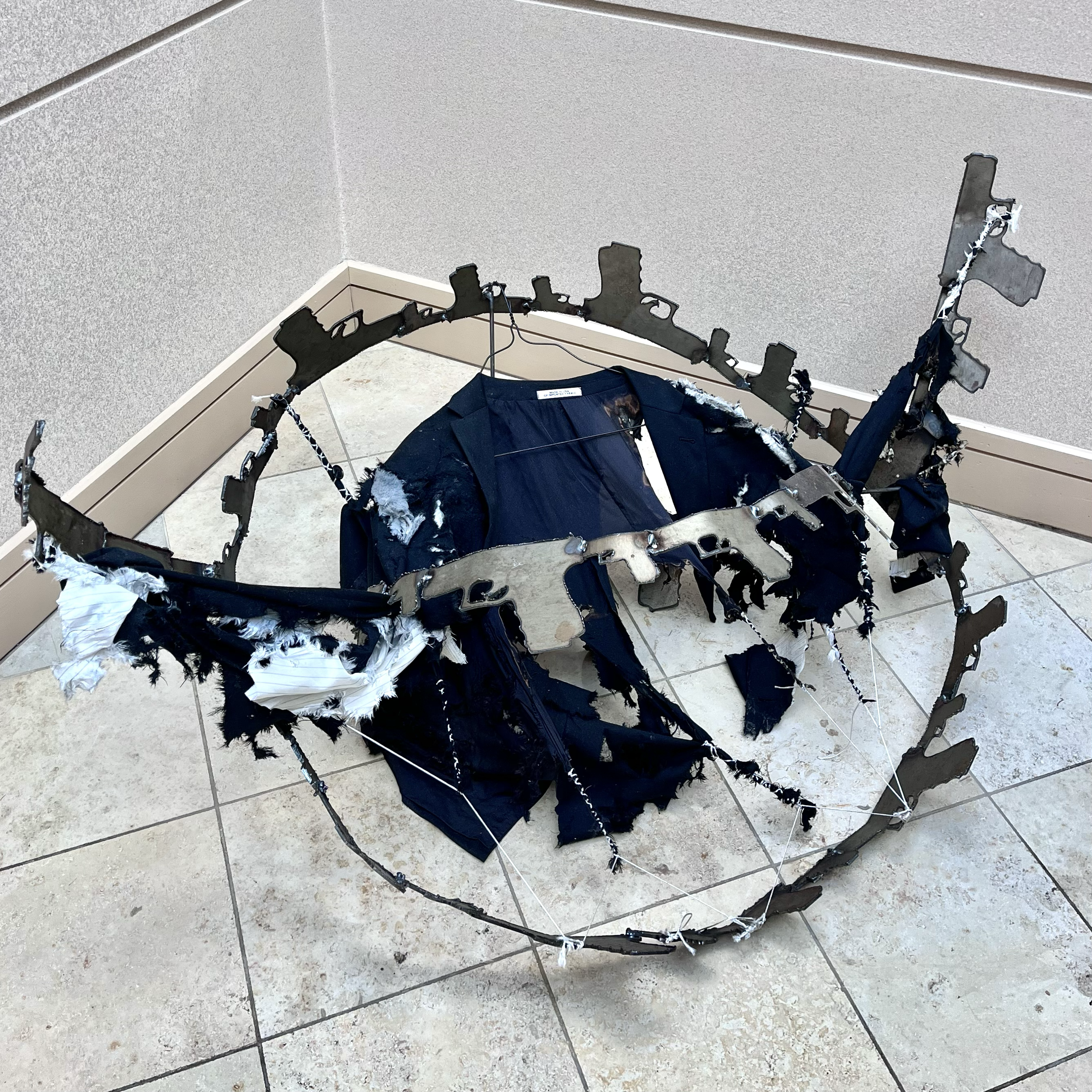 A Hole Where One Should Not Be, 2024. Suit jacket, metal, and thread 