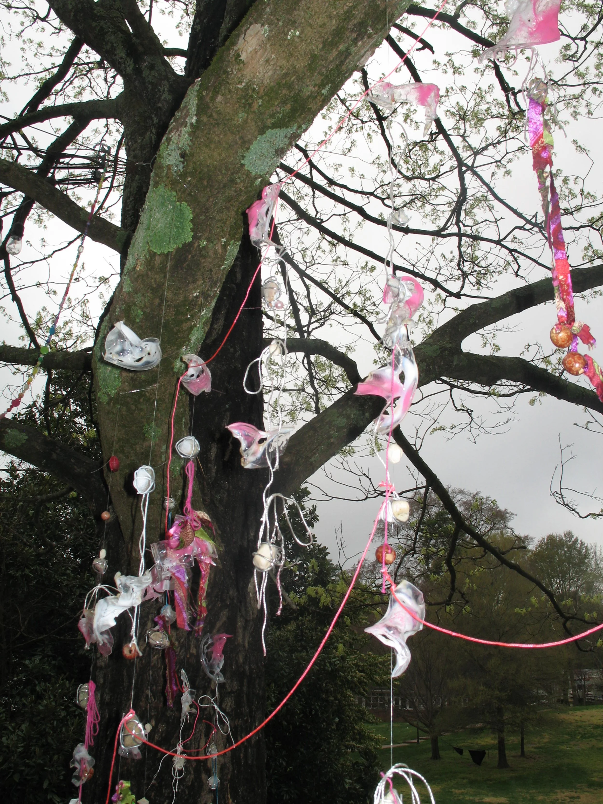 Gemeinschaft, 2025. Fishing line, beads, blow-torched cups, spray paint, and fabric