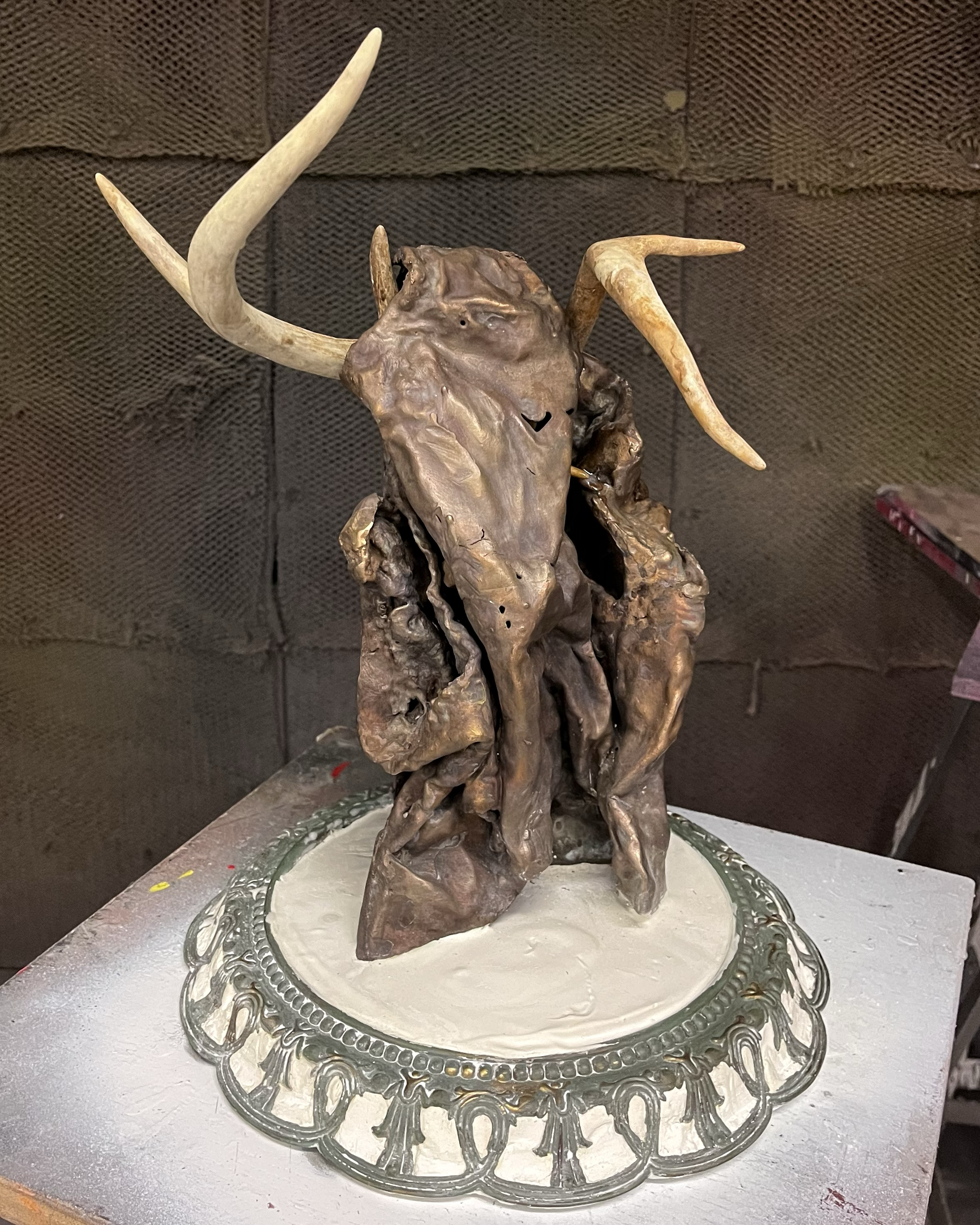 Female Robbery, 2024. Bronze, plaster, deer antlers and clock frame