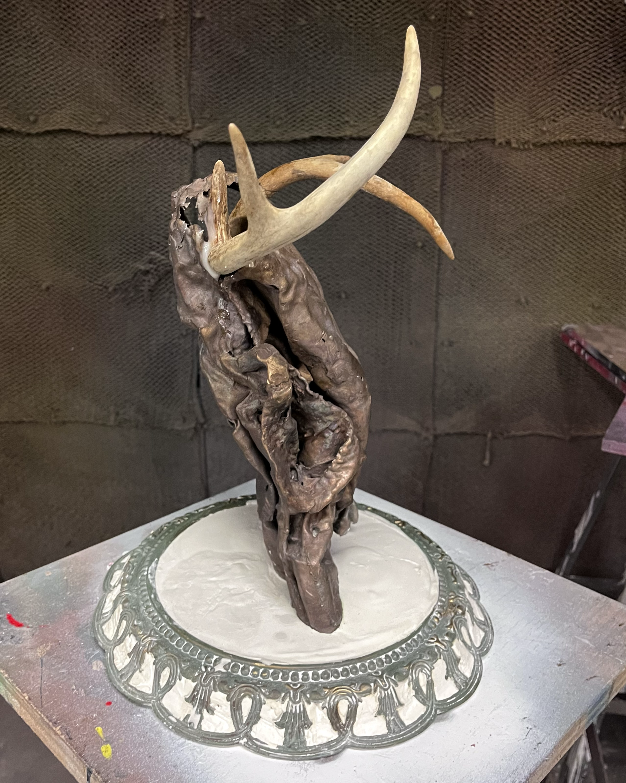 Female Robbery, 2024. Bronze, plaster, deer antlers and clock frame